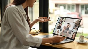 Woman sitting at desk while on virtual meeting,