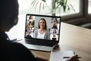 Person sitting on desk while receving online classes.