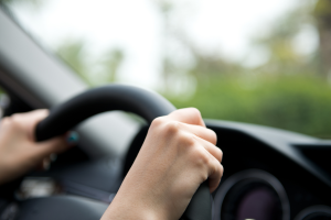 Hands on steering wheel.