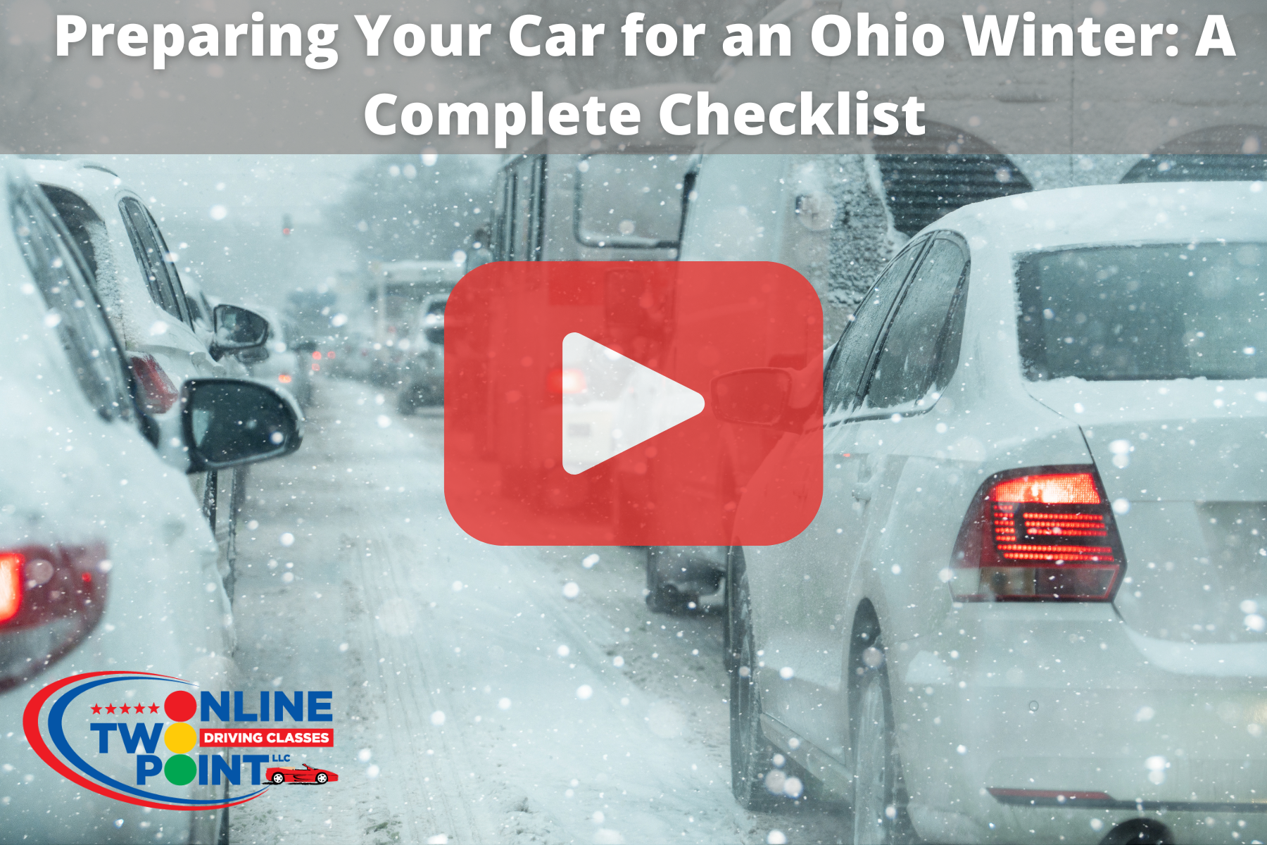 A street scene with several cars driving through heavy snowfall. The road and vehicles are covered in snow, and visibility is reduced.