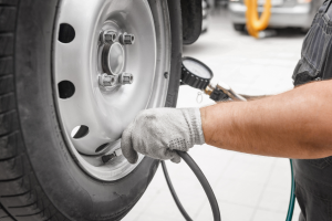 Person checking tire pressure.