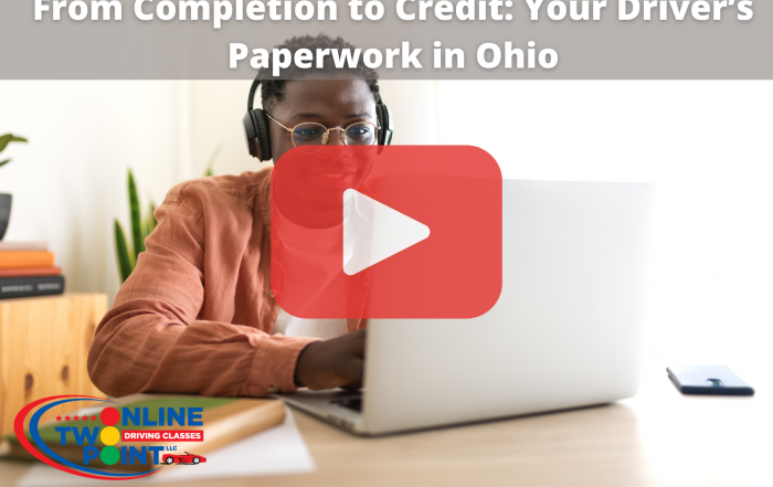 Man sitting on desk while using laptop with red play button overlay and words: rom Completion to Credit: Your Driver’s Paperwork in Ohio