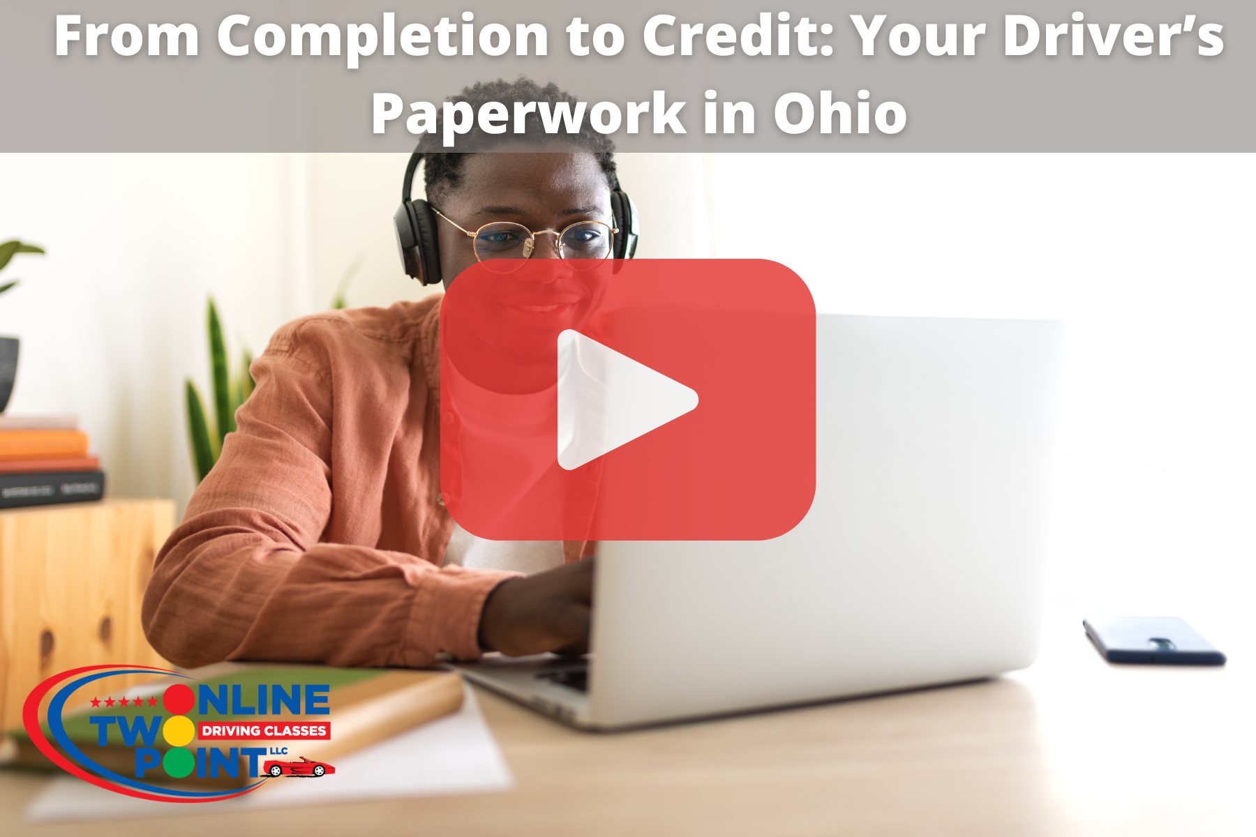 Man sitting on desk while using laptop with red play button overlay and words: rom Completion to Credit: Your Driver’s Paperwork in Ohio