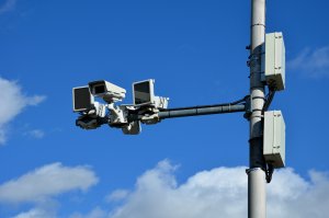A camera system monitoring the speed of traffic vehicles.
