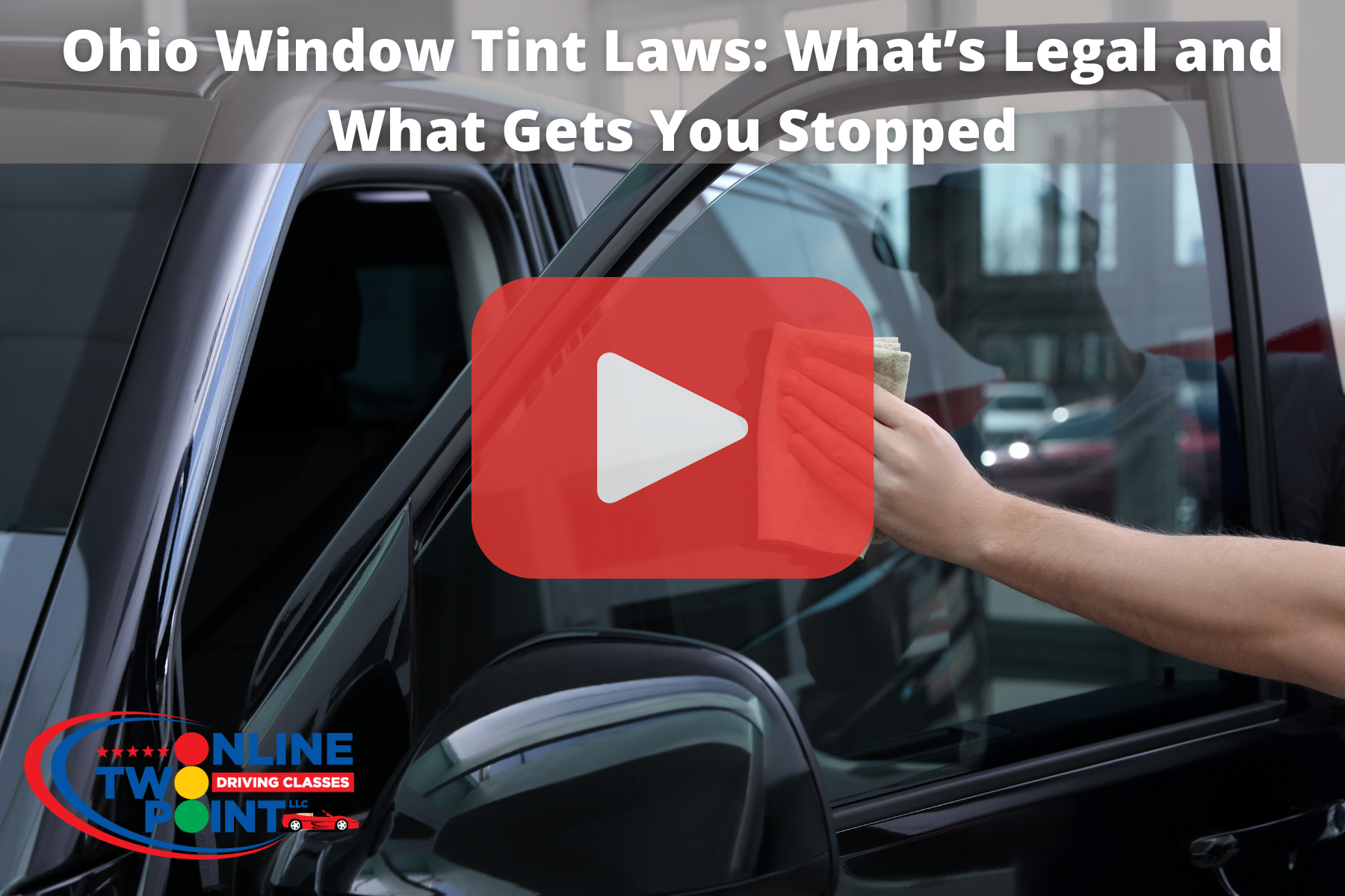 Car window with tint and red play button overlay.