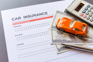 Paper with words car insurance with car toys.